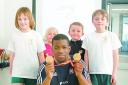 Sprinter Leon Baptise shows his two gold medals that he won at the Commonwealth games in Delhi to from left Jemma Radmore, Leona Stokes, Harvey Barker and Elliot Booth.