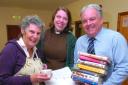 John Chedgzoy (right), Herefordshire Council libraries manager, helps Helen Roberts (centre) and Ann Harris (left) set up Brimfield’s village hall library, 114317-1.