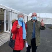 Two happy people after being amongst the first to get a jab at Ludlow racecourse