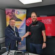 Wayne Flynn, founder of INTune Radio, shakes hand with Ian Groves of Start Tech
