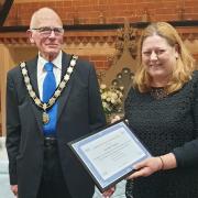 Louise Taylor is presented with a certificate of commendation from Tenbury mayor David Patrick