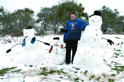 Daniel Cox with his snow 'family', in Newnham Bridge.