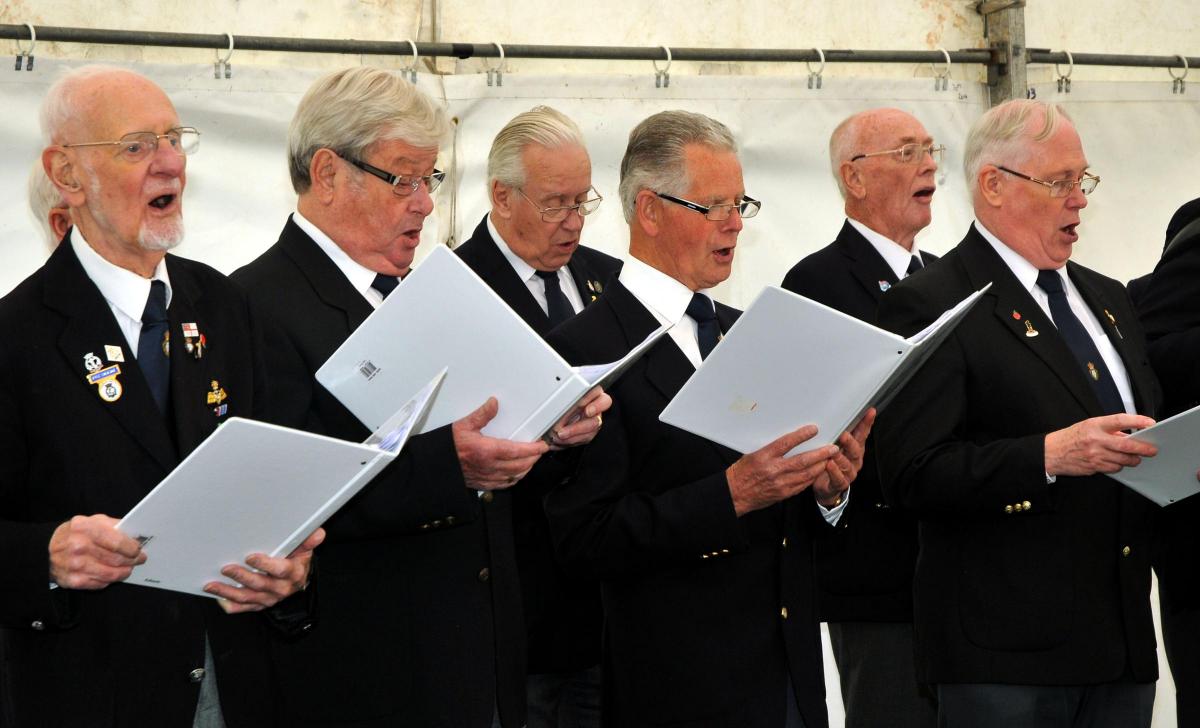 Tenbury Wells and District Royal British Legion choir members sinf in the entertainment marquee.