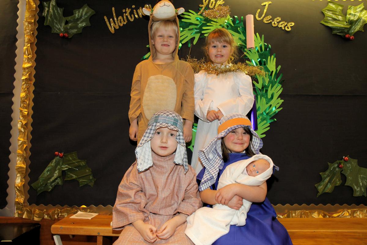 At St Laurence’s CE Primary School, Reception pupils performed a Pop-Up Nativity. Rear, standing: Sabyan Hands (Camel) and Eva Owen (Angel). Front, seated: Charlie Maliacek-Morgan (Joseph) and Lexie Chater-Humphries (Mary)