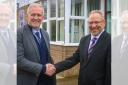 Mike Cloherty (left) is congratulated by current headteacher Simon Goodwin (right) after being appointed his successor at South Wirral High School