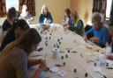 People painting glass at a workshop in Ludlow