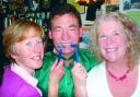 Mick Evans with Rachael Allen (left) and Anne Price (right) after completing the big shave-off.