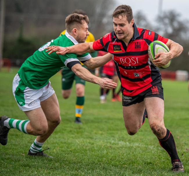 Ludlow centre Will Hodnett evades the Sutton Coldfield fullback en route to scoring try in his team’s 38-12 win over Sutton Coldfield at the The Linney. Picture: Trevor Patchett
