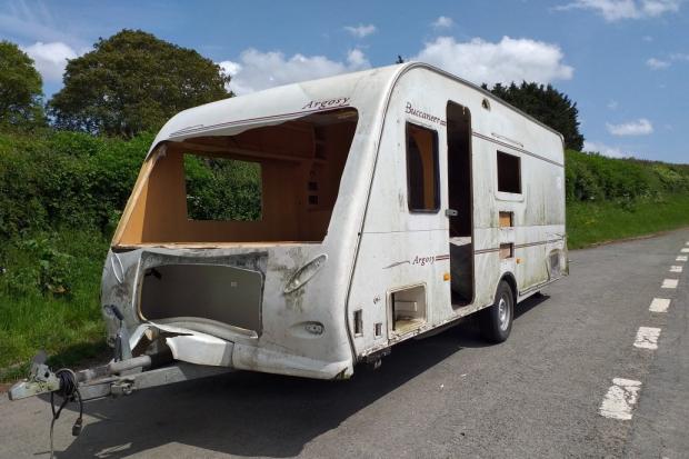 This caravan has been left on the side of the A438