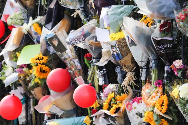 Ludlow Advertiser: Floral tributes left outside Bishops Castle Rugby Club on Brampton Road..
