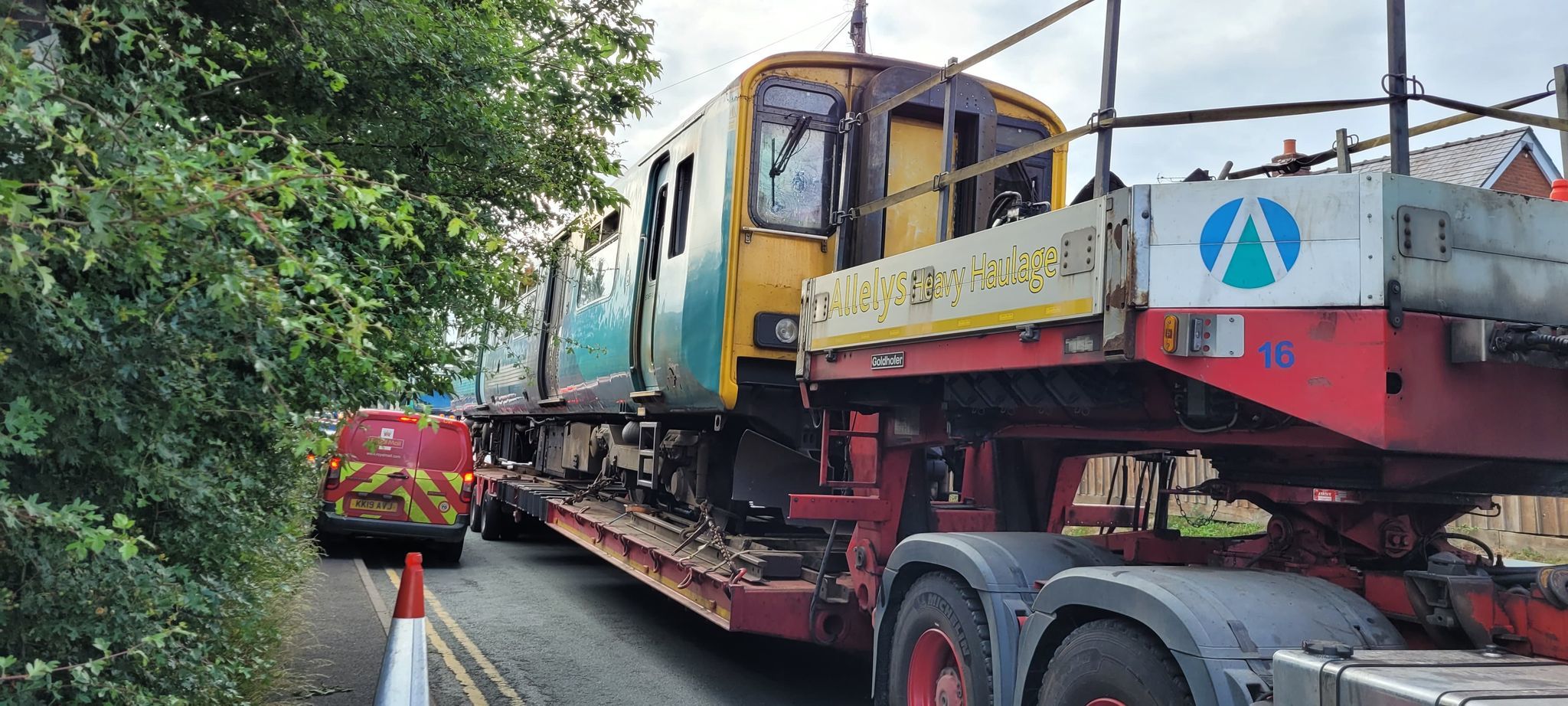 The burnt Transport for Wales train, which crashed into a digger near Craven Arms, were seen on the back of lorries on the A49. Picture: Sam Putterill-Evans