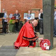 Ludlow Mayor Glenn Ginger lays a wreath on behalf of the town