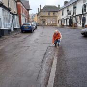 Nigel Hartin examines a stretch of road in need of repair