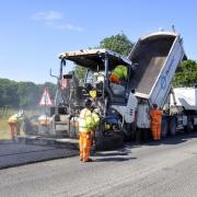 A repair gang at work resurfacing a road in Shropshire