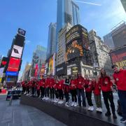 The group from Vision Arts Academy and Ludwig Theatre Arts line up for a photoshoot in Times Square, New York.
