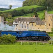 The glorious Sir Nigel Gresley steam locomotive thunders past Stokesay Castle