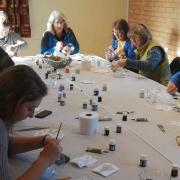 People painting glass at a workshop in Ludlow