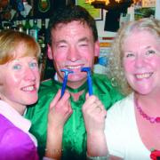 Mick Evans with Rachael Allen (left) and Anne Price (right) after completing the big shave-off.