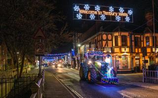 A lit-up tractor goes through Teme Street
